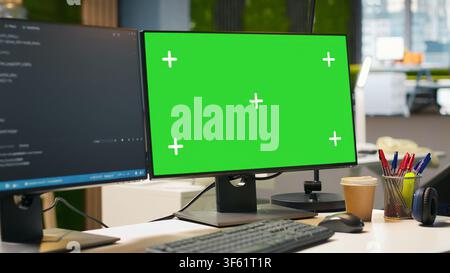 Isolated screen computer monitor in modern startup office displaying code snippets in various programming languages used for application development. Mockup PC in empty software agency workspace Stock Photo