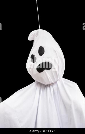 Black and White Halloween Ghost Mask with Scary Skull Face Dark Horror Monster Costume Isolated on black background Symbol for Spooky Celebration Stock Photo
