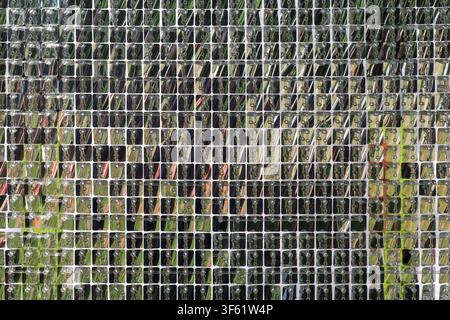 Reflective silver sequin wall mosaic, geometric shimmering background texture for luxury event backdrop, disco decor, futuristic design and modern architecture. Stock Photo