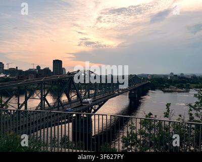 Ottawa, Ontario, Canada - June 30, 2026: Sunset view of Alexandra Bridge over Ottawa River with Gatineau city skyline Stock Photo