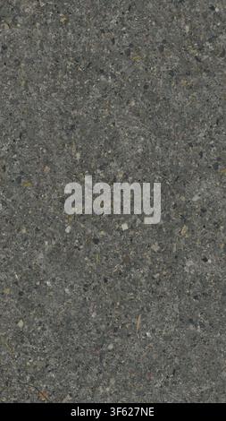 A close-up vertical view of dark grey asphalt aggregate pavement texture. Stock Photo