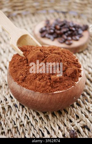 Coffee powder in a wooden bowl and roasted beans Stock Photo