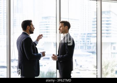 Multiethnic businessmen discuss corporate project, planning business strategy in office Stock Photo