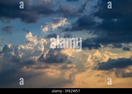 Dramatic evening sky with cumulus clouds. Stock Photo