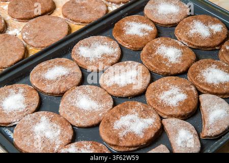 Making homemade cookies in the kitchen. Cookies on a metal sheet. Stock Photo