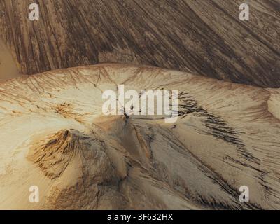 Aerial view of sand textures forming intricate patterns and ridges on a large pile of sand in Poland. Stock Photo
