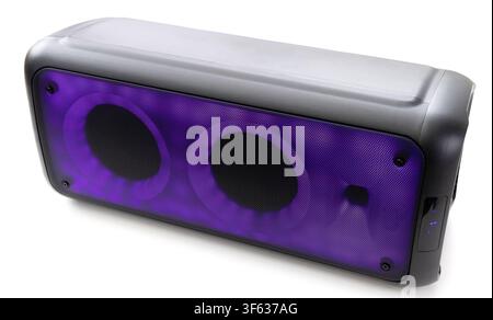 A modern portable bluetooth speaker with vibrant purple LED lighting sits isolated on a white background Stock Photo