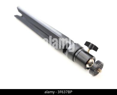 A closeup studio shot of a compact black folding tabletop tripod isolated on a white background Stock Photo