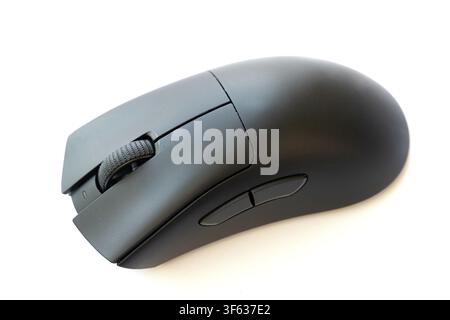 A sleek, black ergonomic computer mouse with a scroll wheel and side buttons is isolated against a clean white background Stock Photo