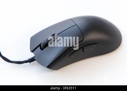 A close up view of a modern black wired computer mouse isolated on a white background Stock Photo