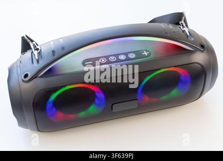 A modern portable wireless bluetooth speaker with colorful LED lights is displayed on a white background Stock Photo