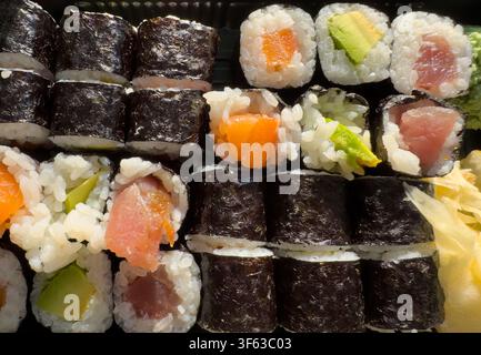 Fresh Maki Sushi Box with Salmon, Tuna and Avocado Enjoyed Outdoors Close up Stock Photo