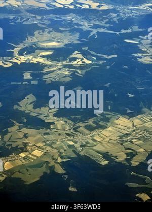 Flying Above fluffy Clouds with Dramatic Scenic Landscape View From High Altitude Stock Photo