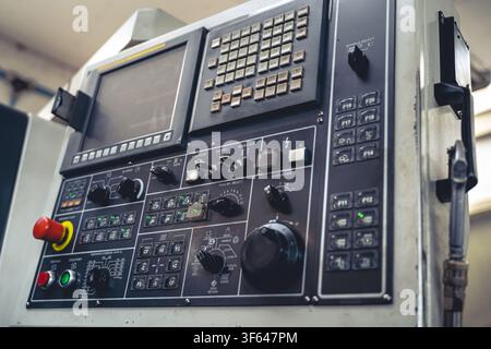 Angle view of industrial CNC lathe controller board with buttons, switches and dials in automated manufacturing plant Stock Photo