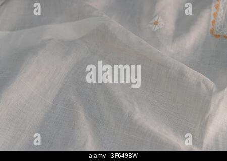 Delicate linen fabric close-up, featuring fine weave, natural fibers, subtle texture, gentle folds and wrinkles, minimalist elegant style, soft diffus Stock Photo