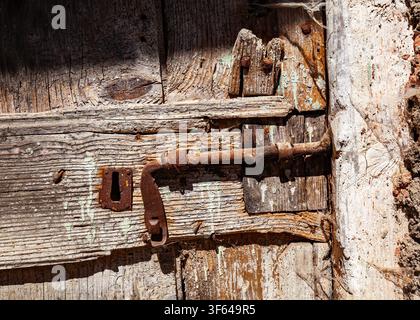 Rusty door bolt on the barn gate, Lombardy, Italy Stock Photo