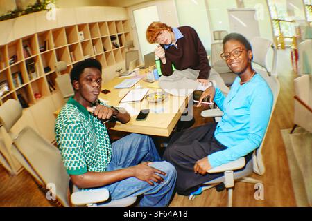 Diverse People Working and Collaborating in Modern Library Stock Photo