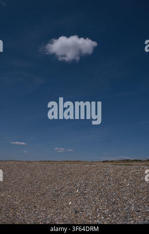 Single white cumulus cloud in Littlehampton, West Sussex in Summer Stock Photo