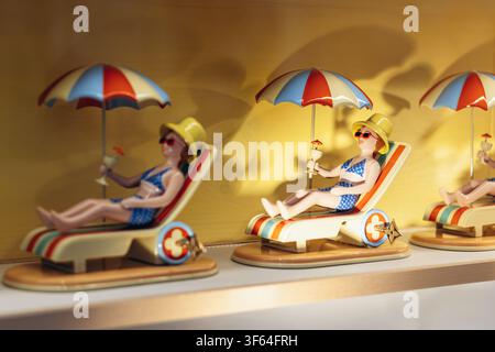 Nice, France - July 27, 2026: Louis Vuitton boutique window display featuring miniature sunbathers beneath umbrellas on Avenue de Verdun Stock Photo