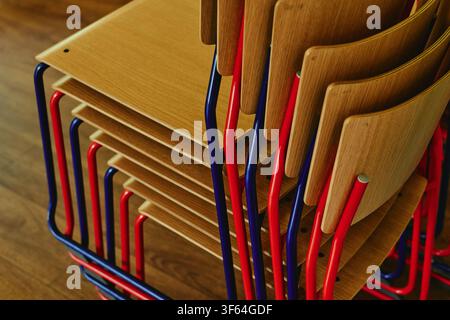 Stacked Wooden Office Chairs Representing Office Organization Stock Photo