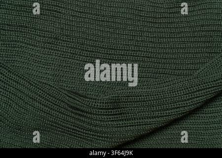 Dark green ribbed knitted fabric texture close up background. Stock Photo