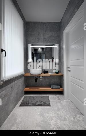 Vertical view of a modern bathroom interior with a white entrance door on the right and a window at the far end. A wooden shelf with a countertop wash Stock Photo