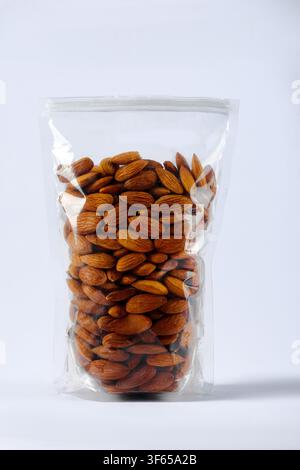 Raw almonds in transparent resealable plastic pouch isolated on white background, food storage concept Stock Photo