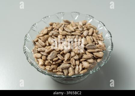 Sunflower seeds in glass bowl isolated on white background Stock Photo