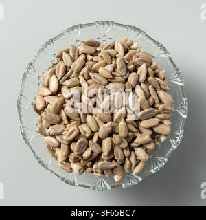 Sunflower seeds in glass bowl isolated on white background Stock Photo