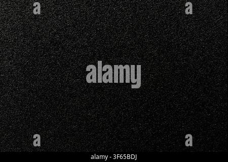 Rough black industrial plastic material surface macro close up view Stock Photo