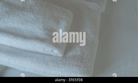 Folded White Cotton Terry Towels Arranged on a Bed in Soft Natural Light — Hotel Hospitality, Clean Linen and Spa Comfort Concept Stock Photo