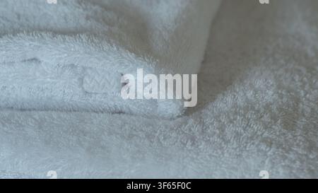 Folded White Cotton Terry Towels Arranged on a Bed in Soft Natural Light — Hotel Hospitality, Clean Linen and Spa Comfort Concept Stock Photo