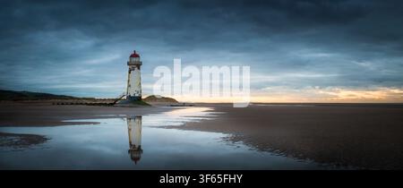 Panoramic landscape of Point of Ayr Lighthouse reflected in a tidal pool on Talacre Beach at twilight, Flintshire, North Wales, UK. Stock Photo