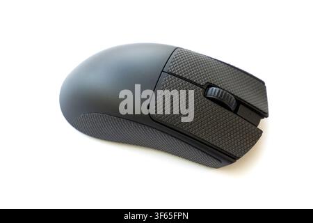 A modern wireless computer mouse with textured grip surfaces is isolated against a clean white background Stock Photo