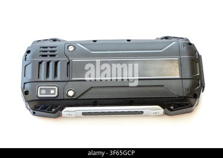 A close up view of the back side of a black and silver rugged smartphone isolated on a white background Stock Photo