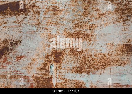 Industrial grunge background texture of heavily rusted metal surface with scratched old paint and brown corrosion spots. Stock Photo