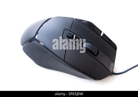 A modern black wired computer mouse sits angled against a clean white background Stock Photo