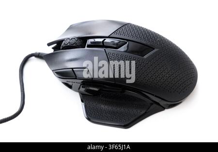A detailed closeup shot of a modern black wired gaming mouse featuring an ergonomic design and textured grips against a clean white background Stock Photo