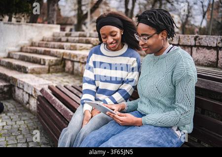 Young African American women sharing digital tablet content Stock Photo