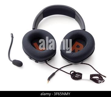 A modern black gaming headset with a detachable microphone and braided cable lies isolated on a plain white background Stock Photo