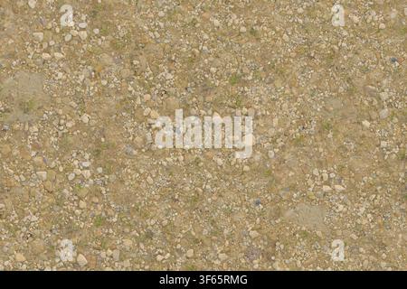 Close up top-down view of small pebbles, gravel, and dirt ground surface. Stock Photo