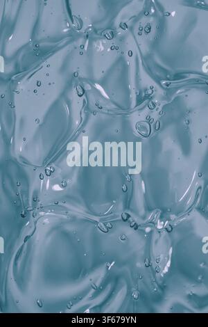 Abstract macro texture of translucent light blue gel with air bubbles and soft flowing shapes, creating a clean liquid background for skincare, wellne Stock Photo