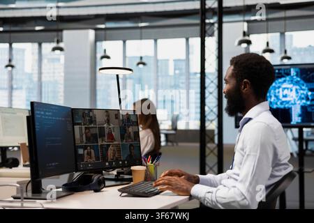 Tech company office team collaborating via videocall, doing brainstorming on backup solutions to protect against data loss. Remote workers doing AI coding during online teleconference Stock Photo