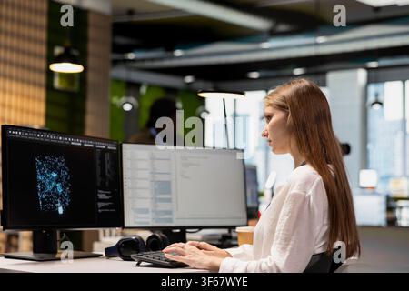 Junior dev using AI LLM chatbot, optimizing company systems performance. Intern using artificial intelligence assistant to convert manual workflows into automated scripts Stock Photo
