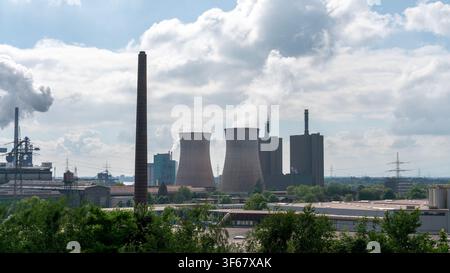 Industrial power plant with cooling towers, smokestacks and factory buildings in Duisburg, Germany. Urban industrial landscape under dramatic cloudy s Stock Photo