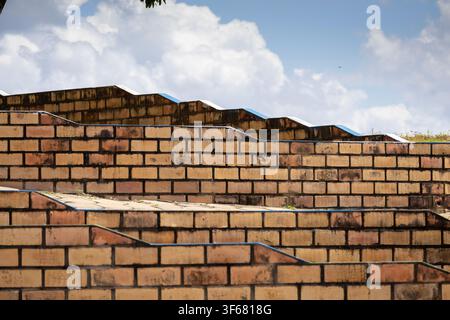 Close-up of a textured pattern red clay brick wall showing an amazing symmetry Stock Photo