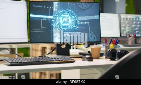 Close up of empty tech startup office with artificial intelligence program running on PC monitors. AI industry startup workspace leveraging machine learning technology, handheld camera shot Stock Photo