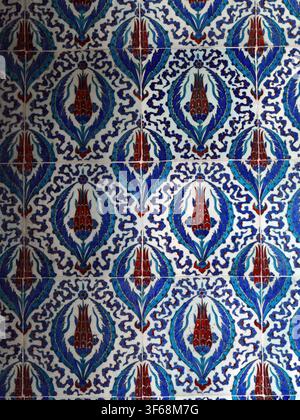 Istanbul - sep 24, 2024 - ceramic tile panel displaying intricate red tulips, blue leaves in classic ottoman turkish decorative pattern, highlighting Stock Photo