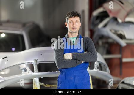 Service station man employee works in repair box, department Stock Photo