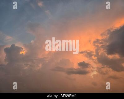 Dramatic sunset sky with beautiful clouds and warm golden light. Stock Photo
